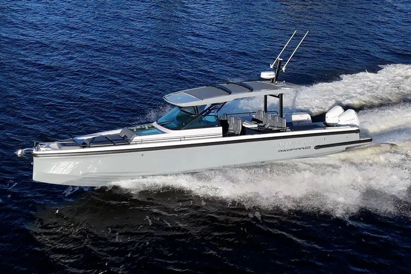 The Image of 2021 Axopar 37 boat cruising on open water, showcasing sleek design and performance. - 1