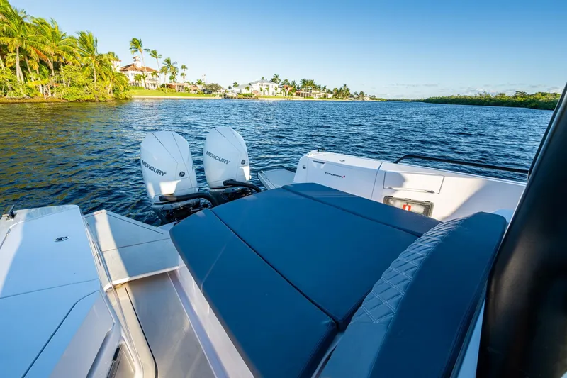 Slide: The Image of 2021 Axopar 37 boat with twin Mercury engines on a scenic waterway. - 19