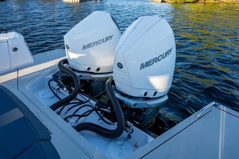 Slide: The Image of Twin Mercury outboard engines on a 2021 Axopar 37 boat, docked on water. - 22