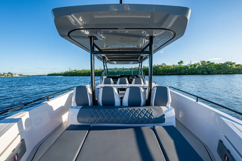 Slide: The Image of 2021 Axopar 37 boat interior with seating, on a sunny day by the water. - 25