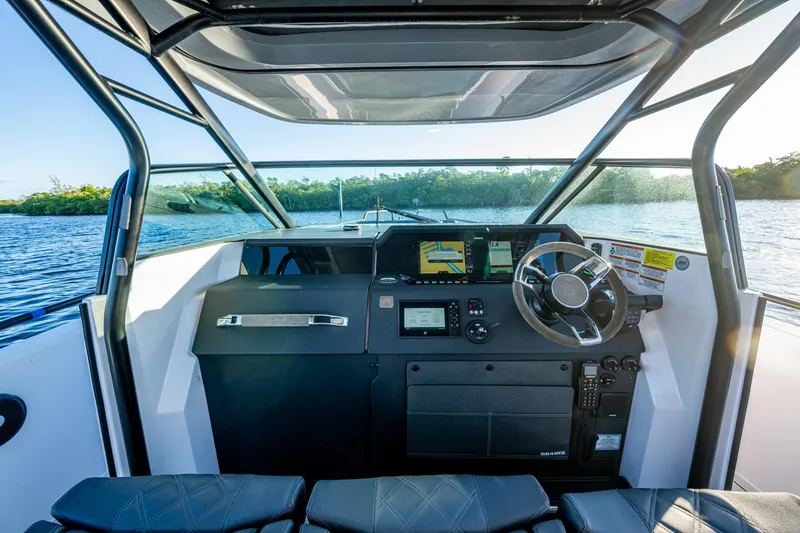 Slide: The Image of 2021 Axopar 37 boat cockpit with modern navigation system and steering wheel. - 29