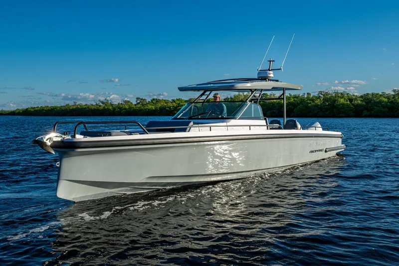 Slide: The Image of 2021 Axopar 37 boat cruising on a sunny day with clear blue skies. - 33