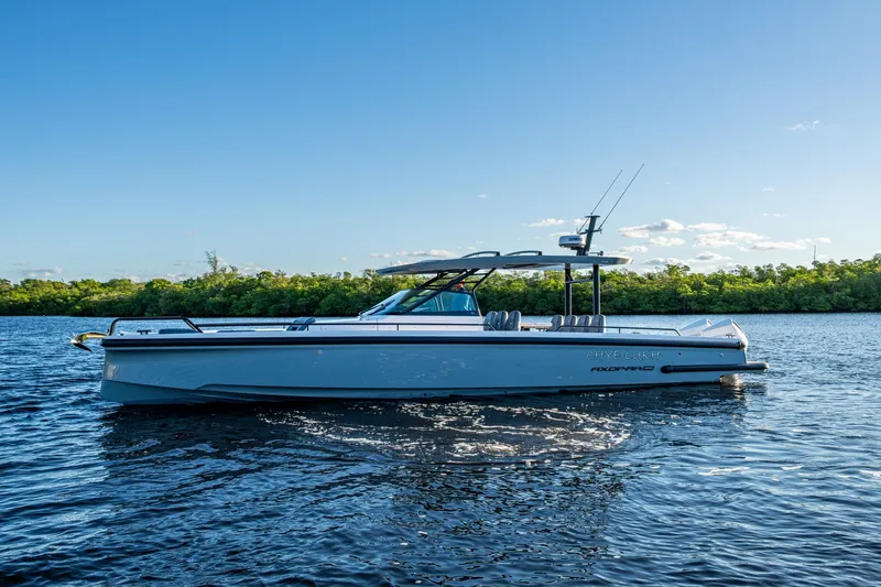 Slide: The Image of 2021 Axopar 37 boat on calm water with clear blue sky background. - 36
