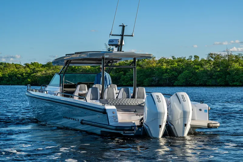 Slide: The Image of 2021 Axopar 37 boat with dual engines on a serene waterway. - 39