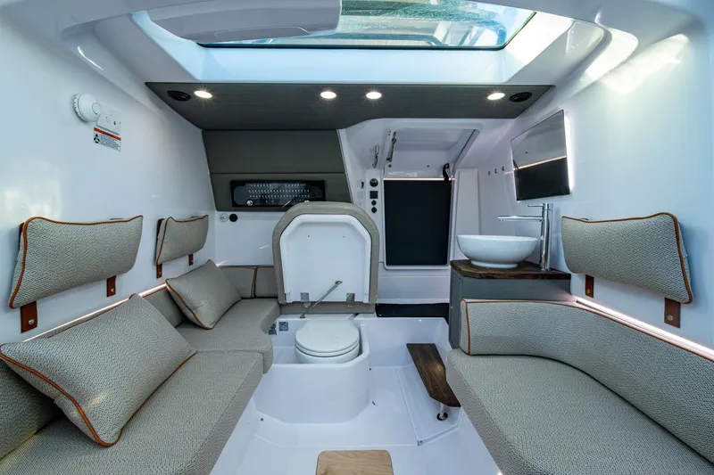 Slide: The Image of Luxurious interior of 2021 Axopar 37 boat with seating, toilet, and sink. - 9