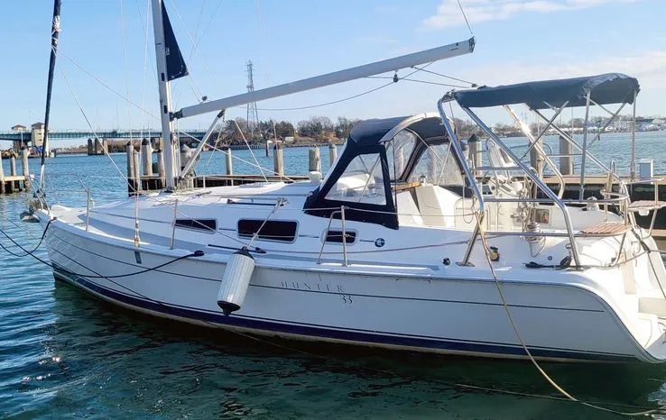 The Image of 2008 Hunter 33 sailboat docked in marina, featuring sleek design and spacious deck. - 0