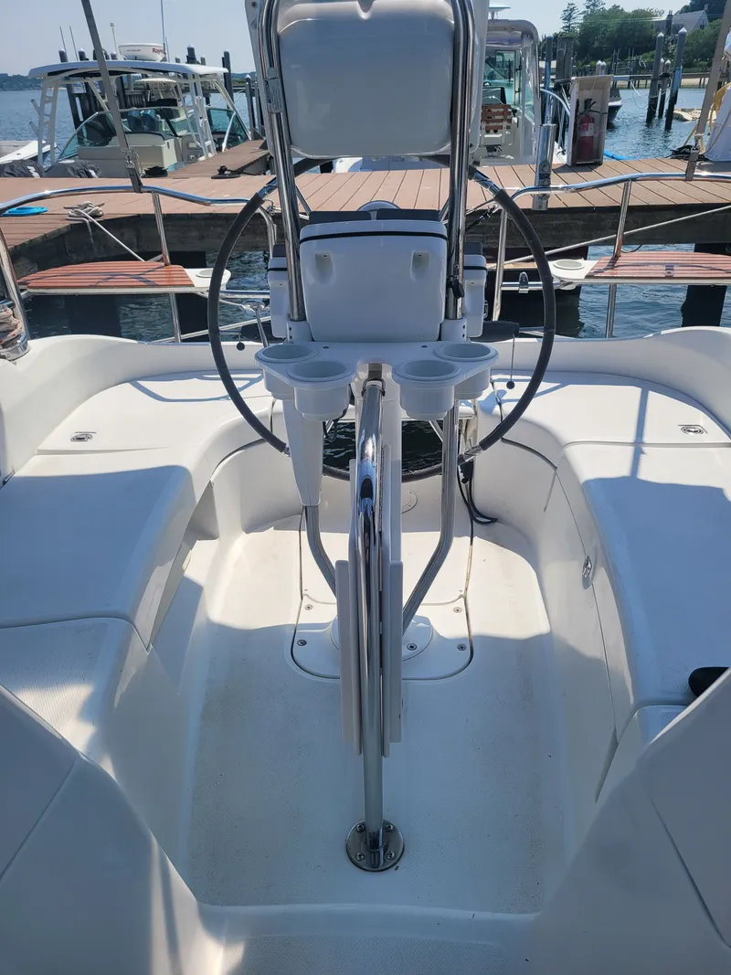 Slide: The Image of Cockpit of 2008 Hunter 33 sailboat with steering wheel and seating, docked at marina. - 1