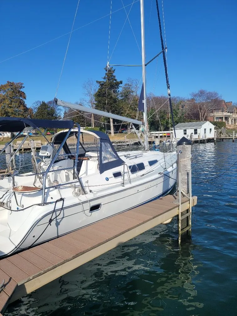 Slide: The Image of 2008 Hunter 33 sailboat docked at a marina on a sunny day. - 11