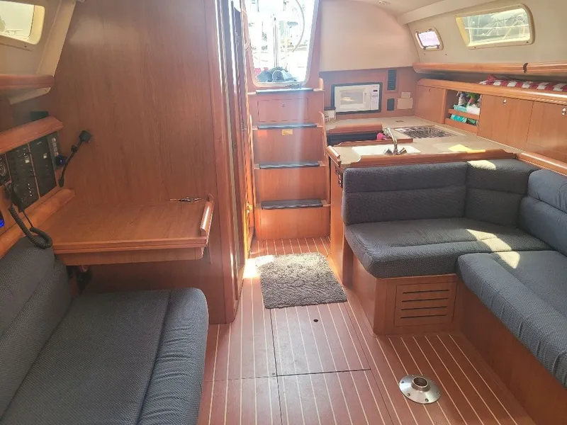 Slide: The Image of Interior of 2008 Hunter 33 sailboat with wood finish and cozy seating area. - 15