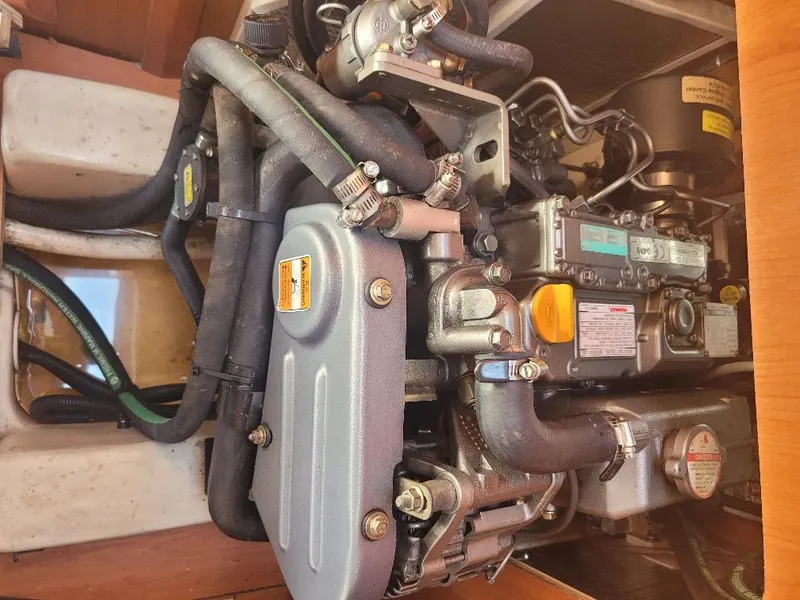 Slide: The Image of Engine compartment of a 2008 Hunter 33 sailboat, showcasing detailed mechanical components. - 18