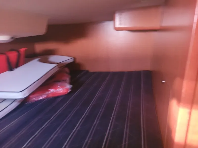 Slide: The Image of Interior cabin of a 2008 Hunter 33 sailboat with striped flooring and storage. - 22