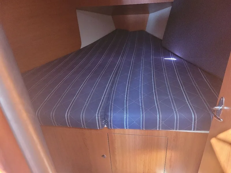 Slide: The Image of Interior cabin of 2008 Hunter 33 sailboat with striped mattress. - 23