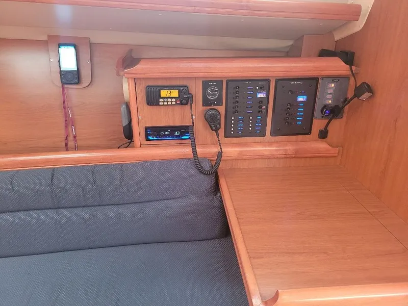 Slide: The Image of Control panel and seating area inside a 2008 Hunter 33 sailboat cabin. - 25