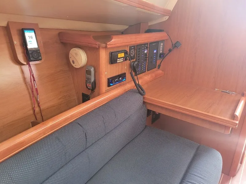 Slide: The Image of 2008 Hunter 33 yacht interior with navigation equipment and seating area. - 26
