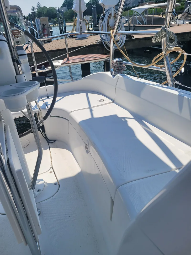 Slide: The Image of 2008 Hunter 33 sailboat cockpit with seating, docked at marina. - 5