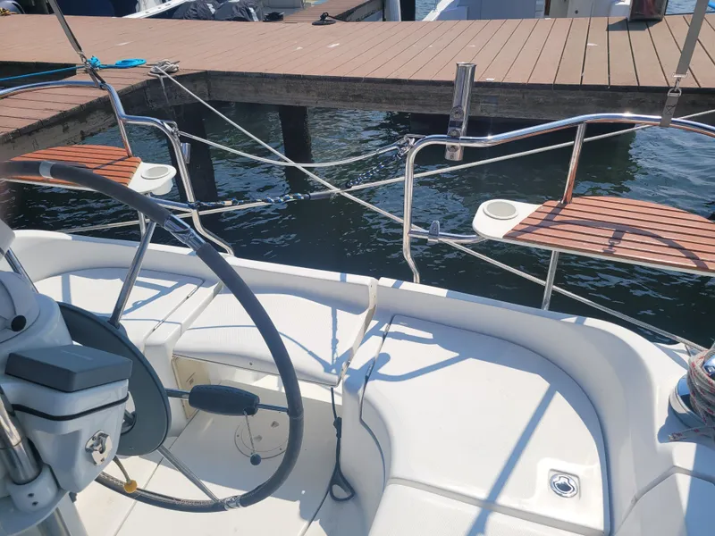 Slide: The Image of Cockpit view of a 2008 Hunter 33 sailboat docked at a marina. - 6