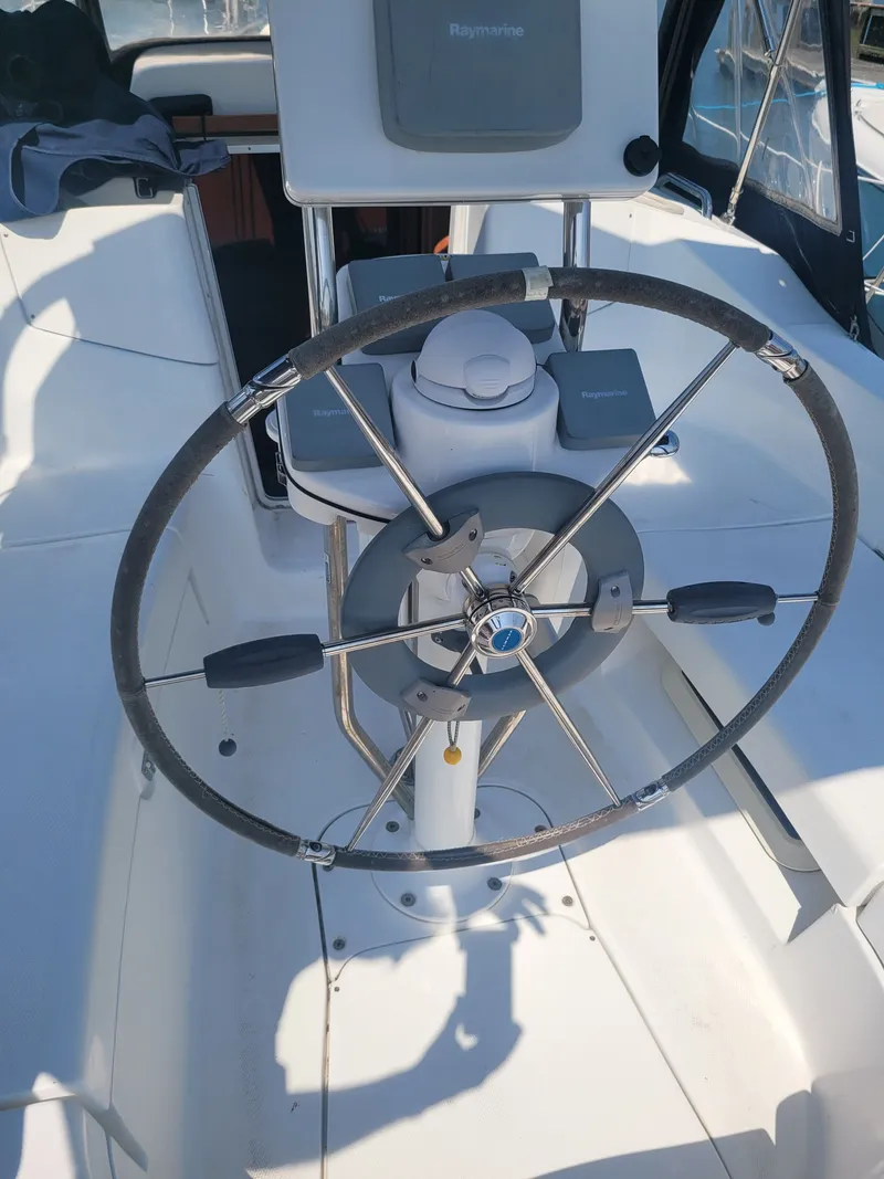 Slide: The Image of Steering wheel of a 2008 Hunter 33 sailboat with navigation equipment. - 7
