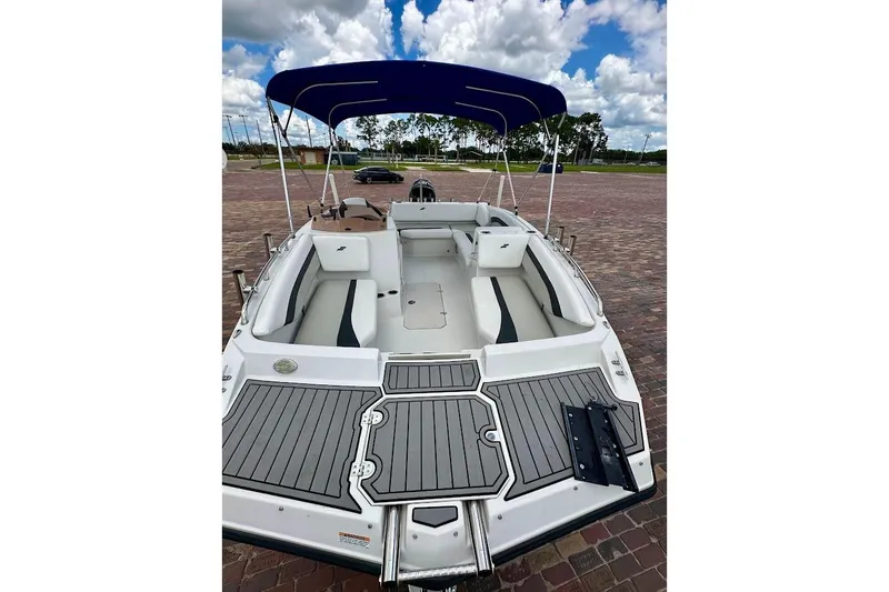 Slide: The Image of 2023 Starcraft SVX 171 OB boat with blue canopy, spacious seating, and sleek design. - 11