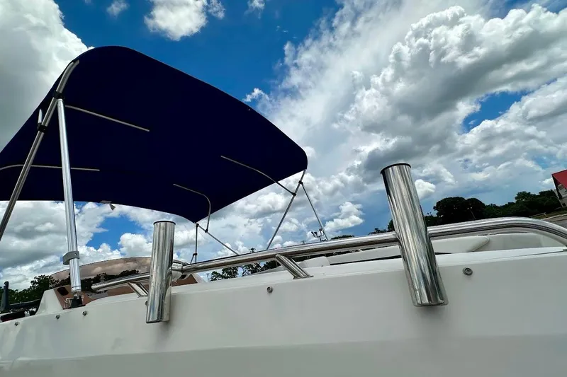Slide: The Image of 2023 Starcraft SVX 171 OB boat with blue canopy under cloudy sky. - 12