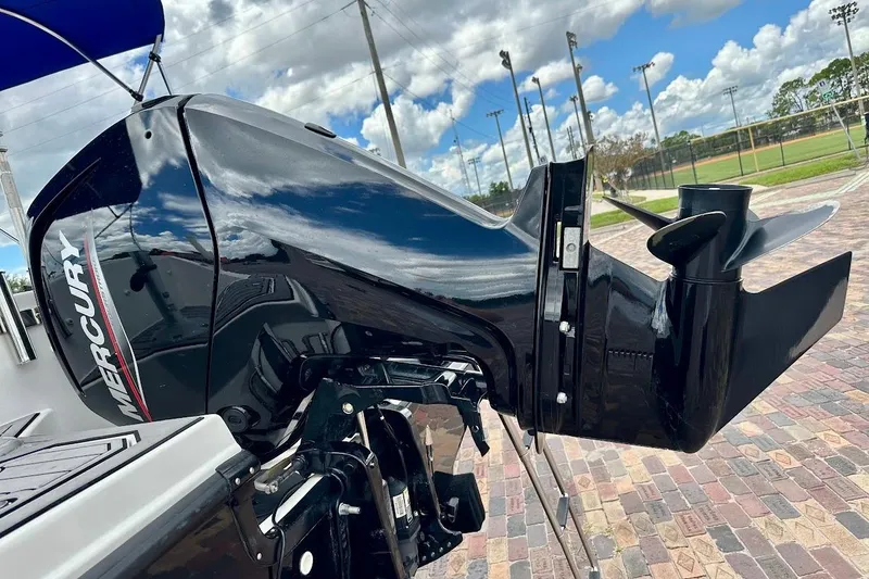 Slide: The Image of 2023 Starcraft SVX 171 OB boat with Mercury outboard motor, parked on brick pavement. - 16