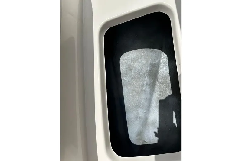 Slide: The Image of 2023 Starcraft SVX 171 OB boat storage compartment, white exterior, shadow visible. - 40