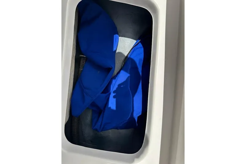 Slide: The Image of Storage compartment of 2023 Starcraft SVX 171 OB boat with blue fabric inside. - 41