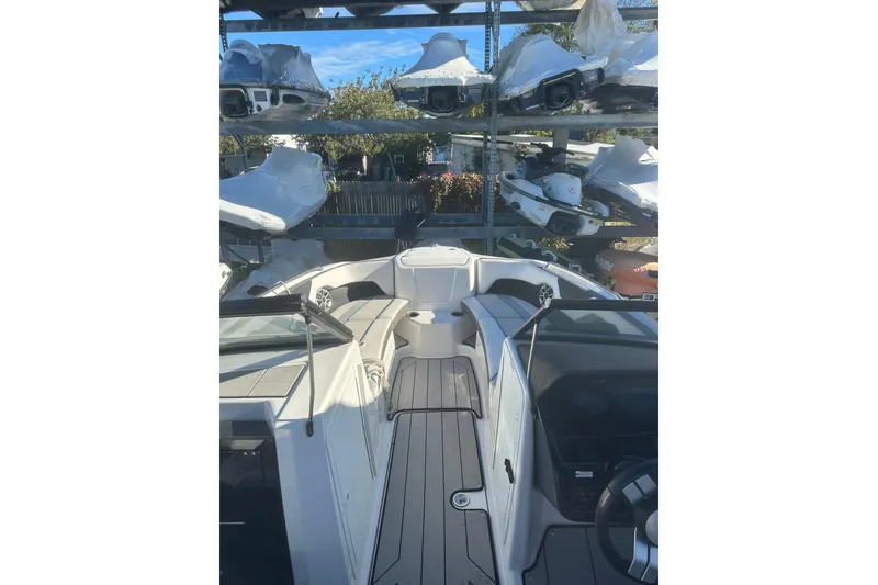 Slide: The Image of 2021 Yamaha Boats 212XE interior with sleek white and black seating. - 13