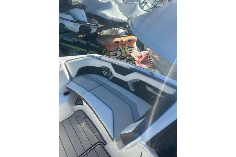 Slide: The Image of 2021 Yamaha Boats 212XE interior with seating and speaker, showcasing modern design. - 16