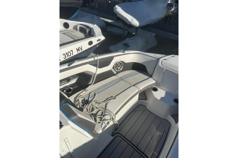 Slide: The Image of 2021 Yamaha Boats 212XE interior with seating and storage compartments. - 17