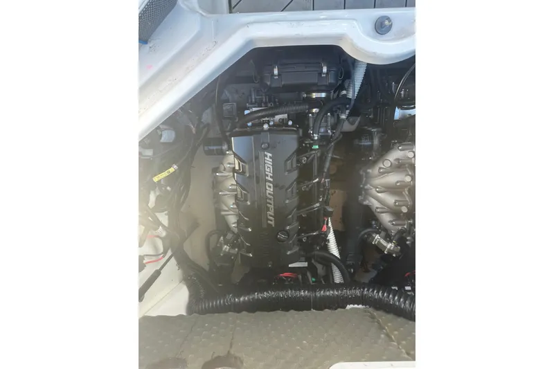 Slide: The Image of Engine compartment of a 2021 Yamaha Boats 212XE, showcasing dual high-output engines. - 23