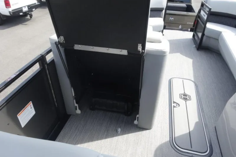 Slide: The Image of 2026 Harris Solstice 250 interior with open storage compartment and seating area. - 6