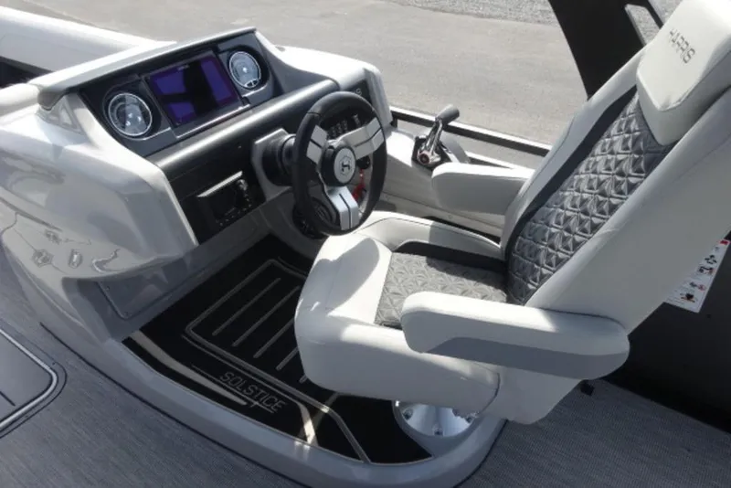 Slide: The Image of 2026 Harris Solstice 250 boat interior with modern dashboard and luxurious captain's chair. - 7