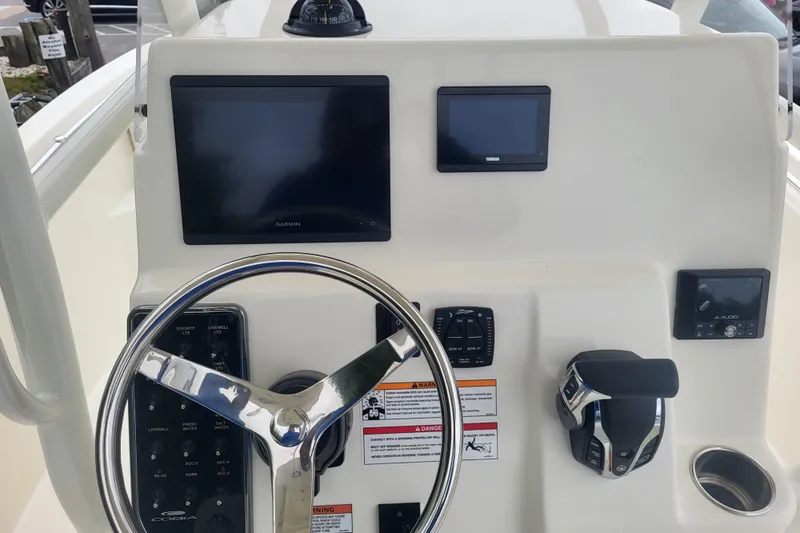 Slide: The Image of 2025 Cobia 220 Center Console dashboard with steering wheel and electronic displays. - 10