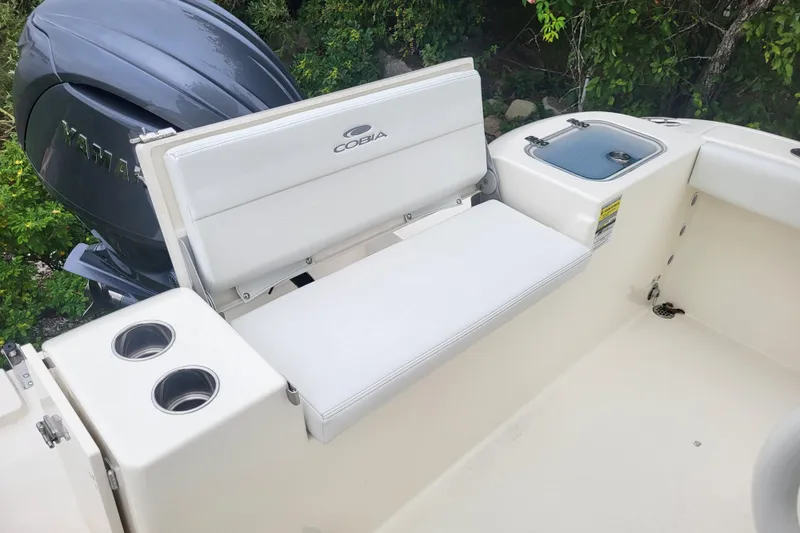 Slide: The Image of 2025 Cobia 220 Center Console boat interior with seating and cup holders. - 4