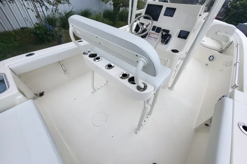 Slide: The Image of 2025 Cobia 220 Center Console boat interior with helm and seating area. - 7