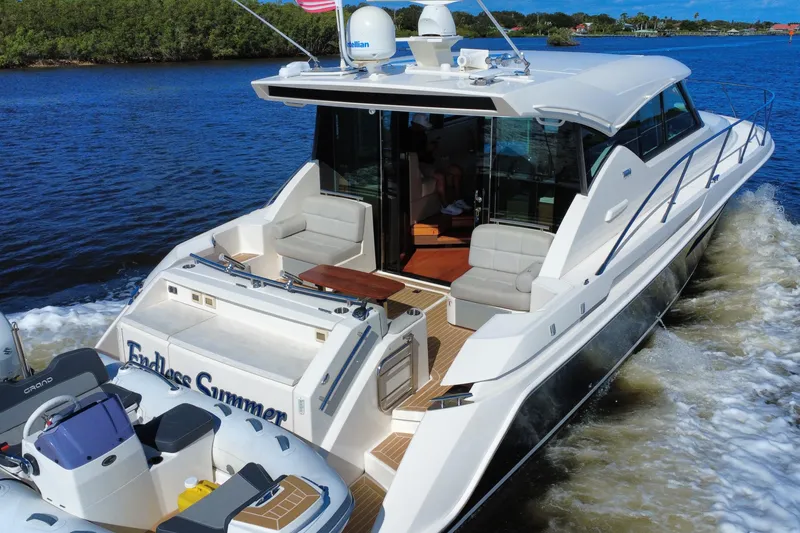 Slide: The Image of 2016 Tiara Yachts C44 Coupe cruising on a scenic waterway. - 12