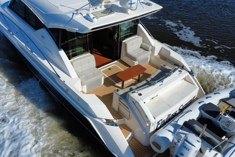 Slide: The Image of 2016 Tiara Yachts C44 Coupe cruising with spacious deck and seating area. - 14
