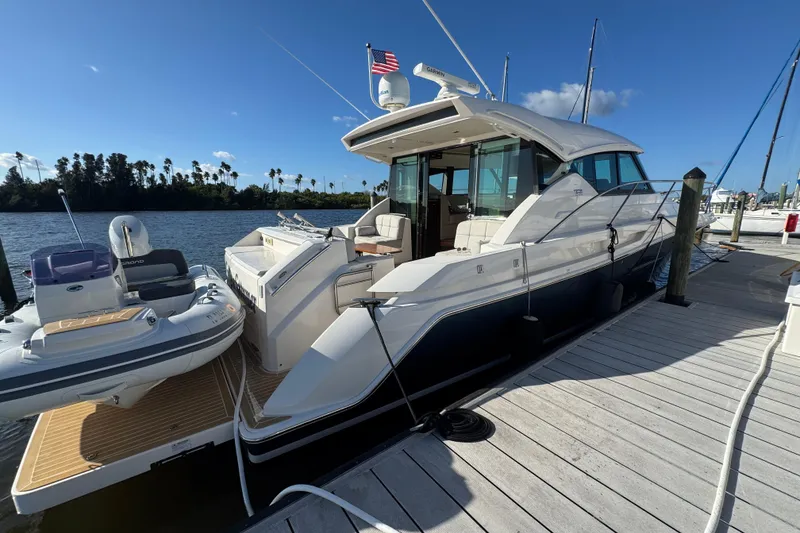 Slide: The Image of 2016 Tiara Yachts C44 Coupe docked, featuring sleek design and luxury amenities. - 15