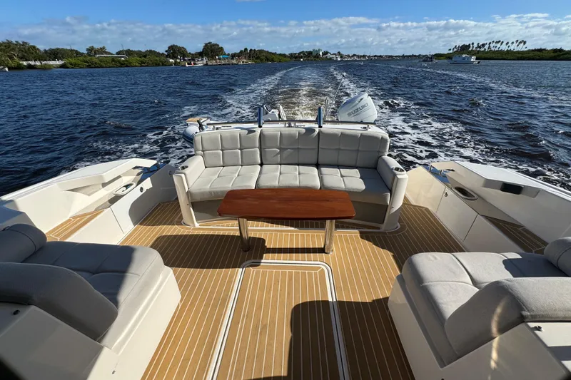 Slide: The Image of 2016 Tiara Yachts C44 Coupe with spacious deck seating on open water. - 23