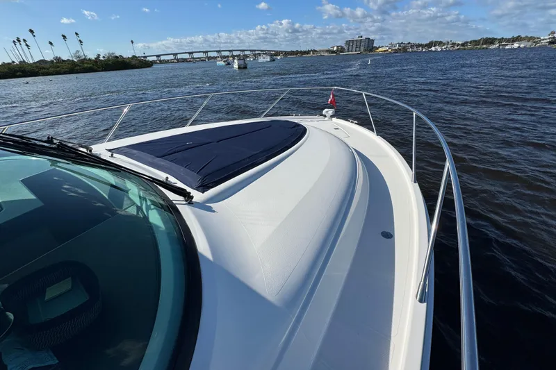 Slide: The Image of 2016 Tiara Yachts C44 Coupe cruising on a scenic waterway with bridge view. - 28