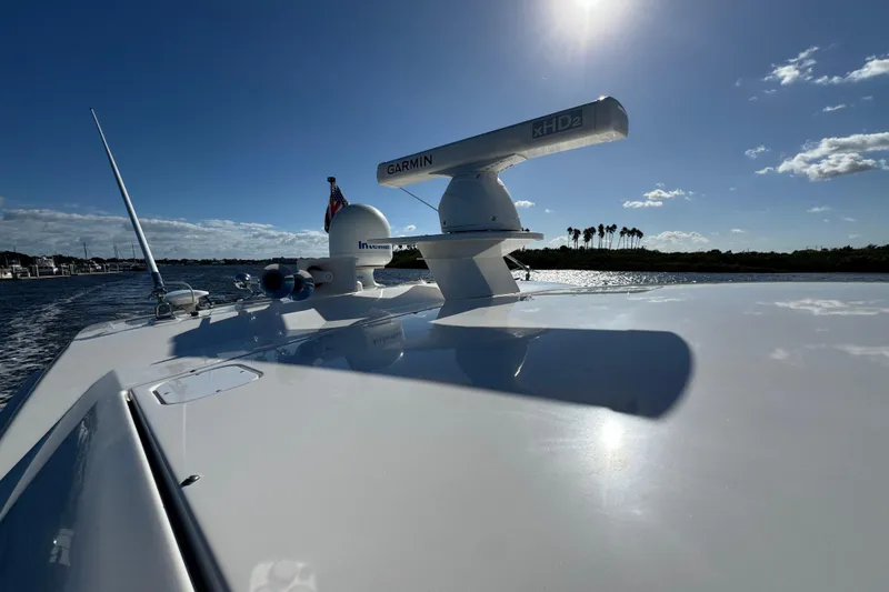 Slide: The Image of 2016 Tiara Yachts C44 Coupe on water, featuring Garmin radar under clear blue sky. - 29