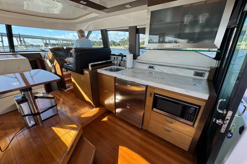 Slide: The Image of Interior of 2016 Tiara Yachts C44 Coupe with modern kitchen and helm station. - 34