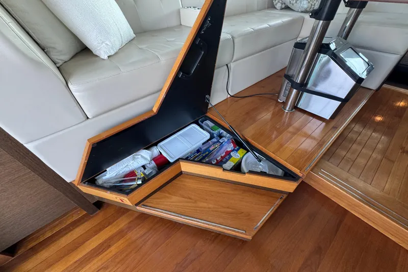 Slide: The Image of Storage compartment on 2016 Tiara Yachts C44 Coupe with various items inside. - 36