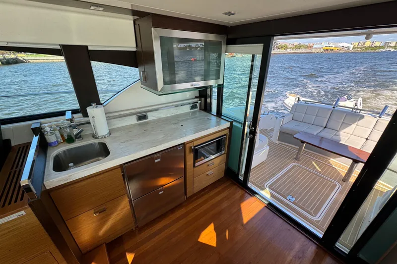 Slide: The Image of Interior of 2016 Tiara Yachts C44 Coupe with modern kitchen and outdoor seating area. - 37