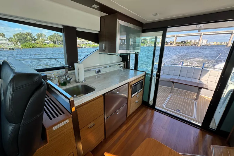 Slide: The Image of Interior of 2016 Tiara Yachts C44 Coupe with kitchen and scenic water view. - 38