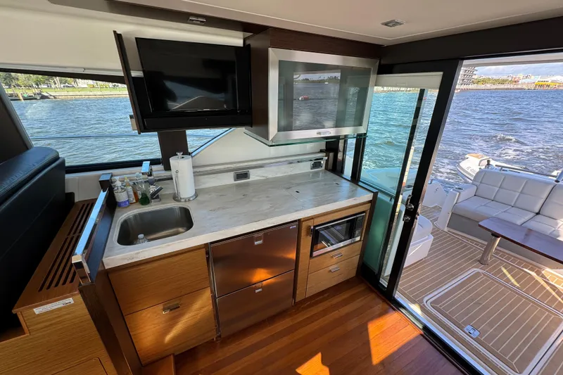 Slide: The Image of Luxurious 2016 Tiara Yachts C44 Coupe interior with modern kitchen and scenic water view. - 39