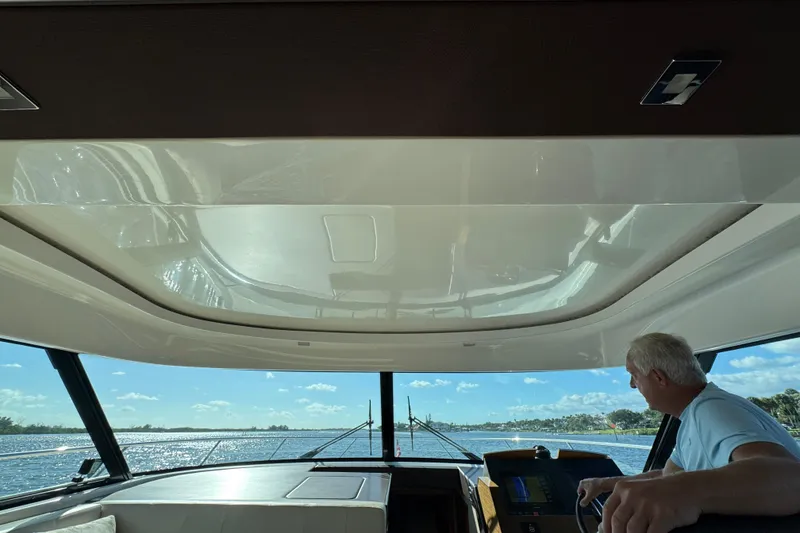 Slide: The Image of Interior view of 2016 Tiara Yachts C44 Coupe, featuring a scenic waterway. - 43