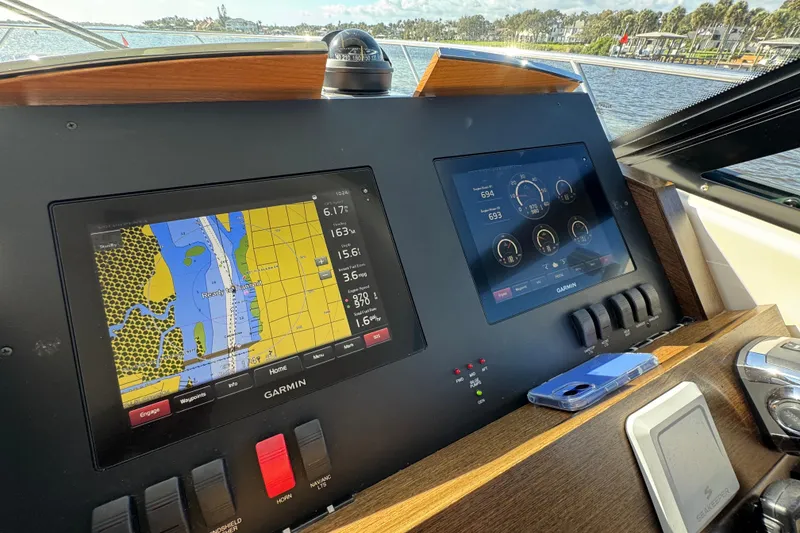 Slide: The Image of Dashboard of a 2016 Tiara Yachts C44 Coupe with Garmin navigation displays. - 46