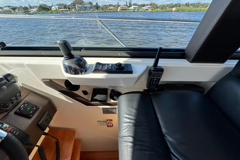 Slide: The Image of 2016 Tiara Yachts C44 Coupe helm with controls and water view. - 47