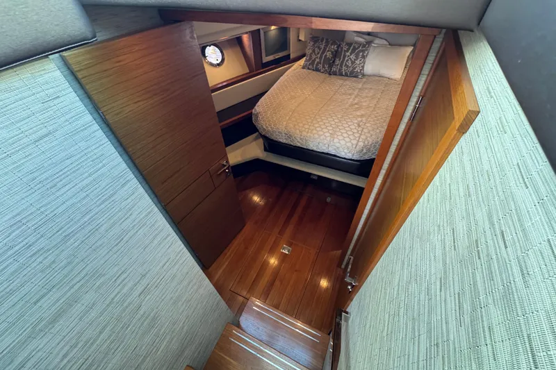 Slide: The Image of Interior cabin of 2016 Tiara Yachts C44 Coupe with wooden flooring and cozy bed. - 50